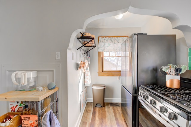 kitchen featuring light hardwood / wood-style flooring and stainless steel range with gas cooktop