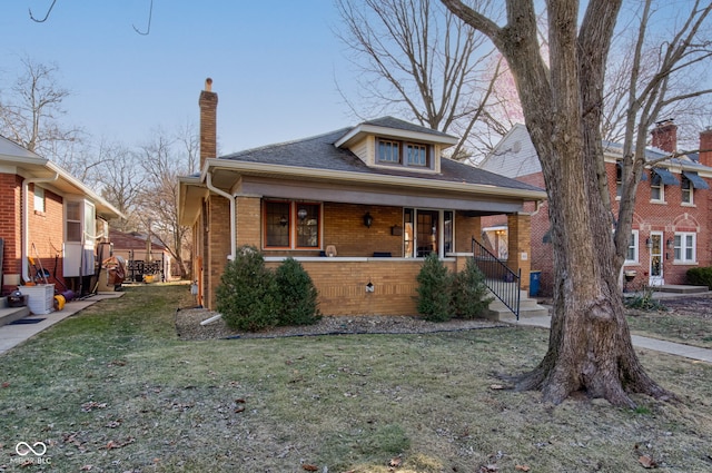 view of front of home with a front yard and covered porch