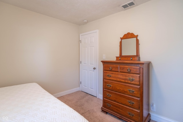 carpeted bedroom with a textured ceiling