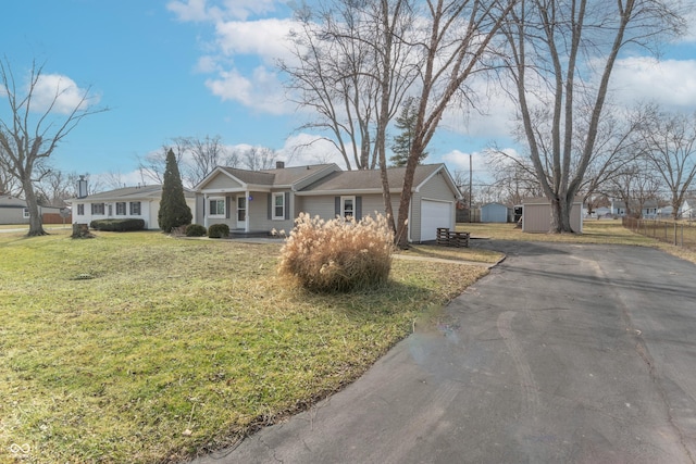 ranch-style home featuring a garage and a front lawn