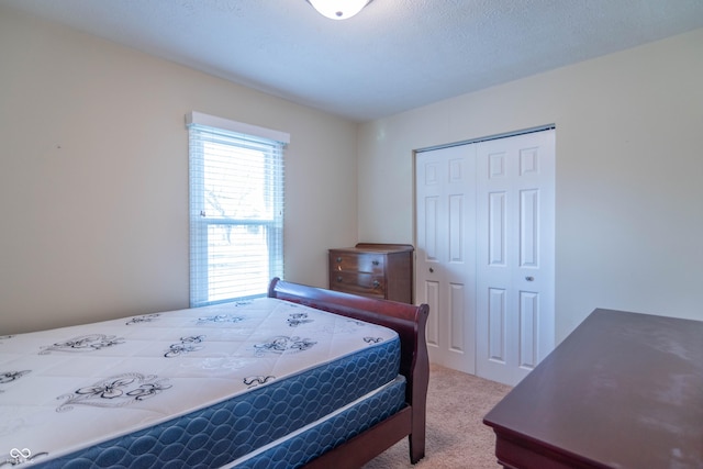 carpeted bedroom with a closet