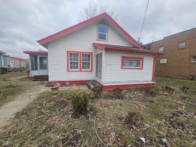 back of property with a sunroom