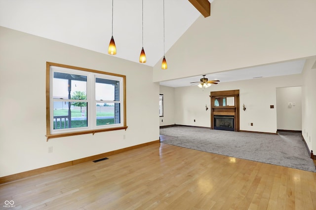 800 N 400 W, Bargersville, IN 46106 - unfurnished living room with wood finished floors, high vaulted ceiling, a fireplace, beamed ceiling, and a ceiling fan
