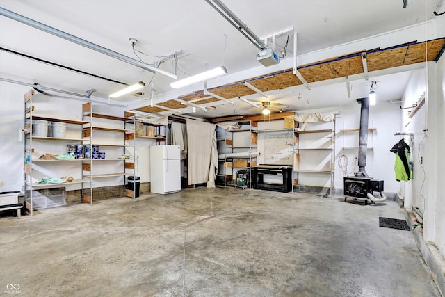 800 N 400 W, Bargersville, IN 46106 - garage featuring freestanding refrigerator, a wood stove, and a garage door opener