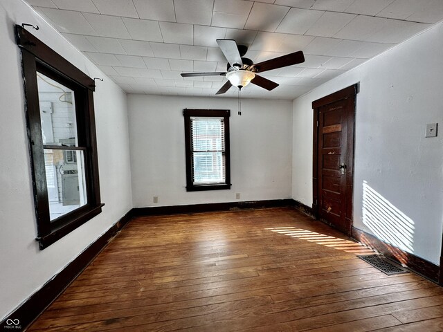 spare room with dark wood-type flooring and ceiling fan