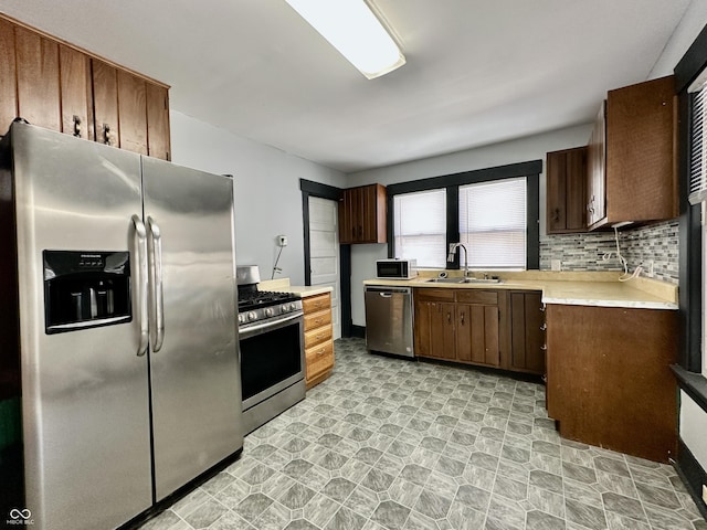 kitchen featuring sink, backsplash, and stainless steel appliances