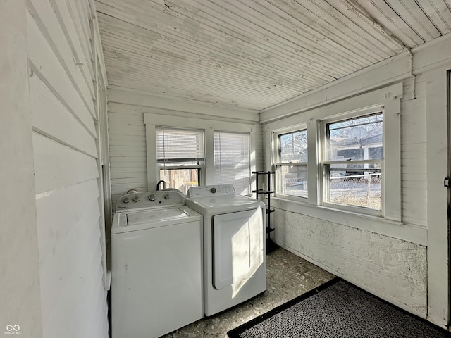 washroom featuring wood ceiling and washing machine and clothes dryer