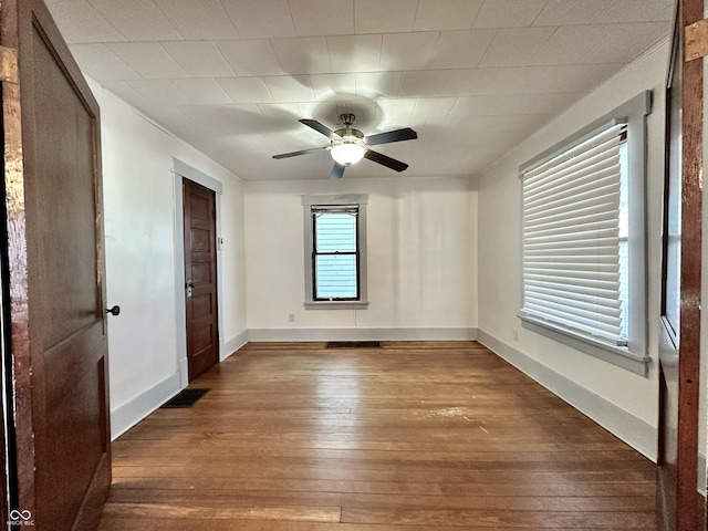 empty room with hardwood / wood-style flooring and ceiling fan