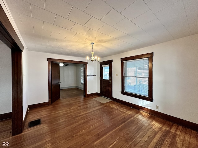 interior space with an inviting chandelier and dark hardwood / wood-style floors