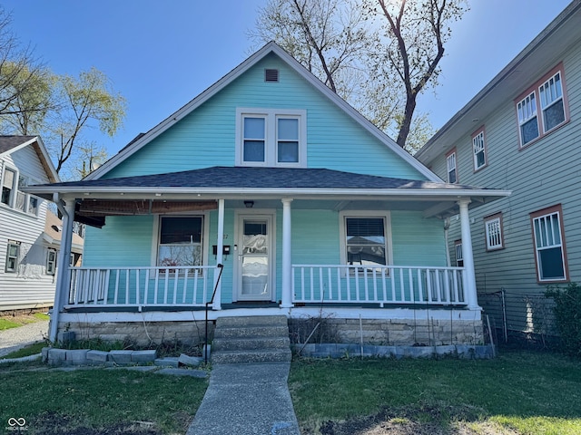 1427 S Washington St, Bloomington, IN 47401 - bungalow-style home with roof with shingles, a front yard, and covered porch