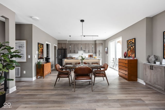 dining space with hardwood / wood-style floors