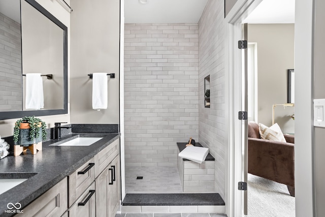 bathroom with vanity and tiled shower