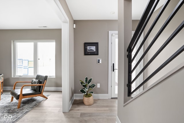 foyer entrance with light wood-type flooring