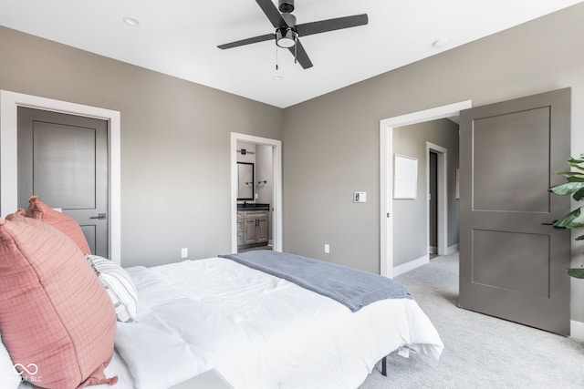 carpeted bedroom with ceiling fan and ensuite bathroom