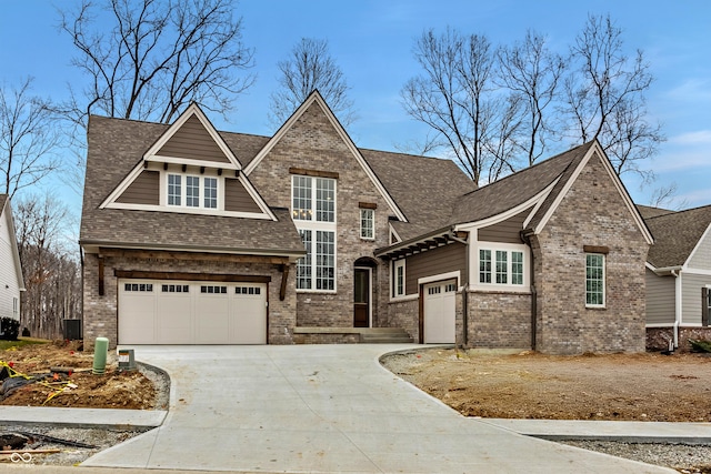 view of front of house featuring a garage, driveway, brick siding, and roof with shingles