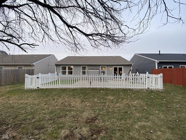 back of house with a yard