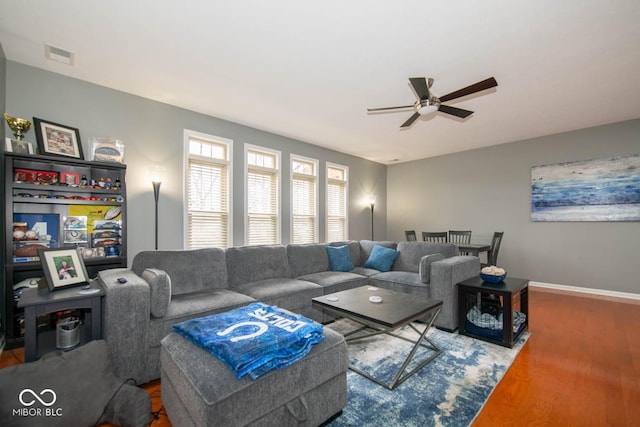 living room with hardwood / wood-style flooring and ceiling fan