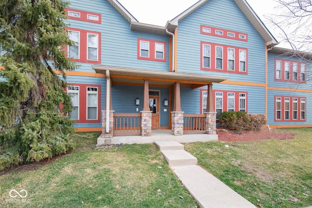 view of front of house featuring covered porch and a front yard