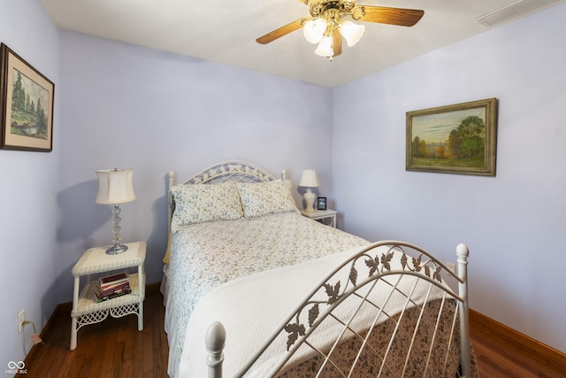 bedroom with a ceiling fan, baseboards, visible vents, and wood finished floors