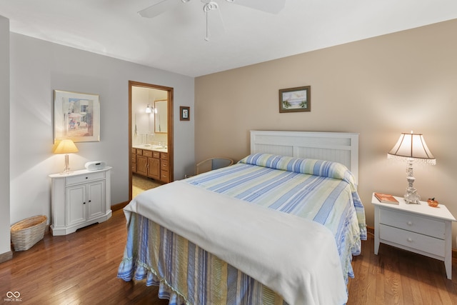 bedroom featuring baseboards, ceiling fan, ensuite bathroom, and wood finished floors