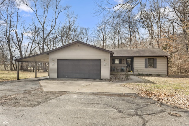 ranch-style house with an attached garage, a porch, aphalt driveway, and a carport