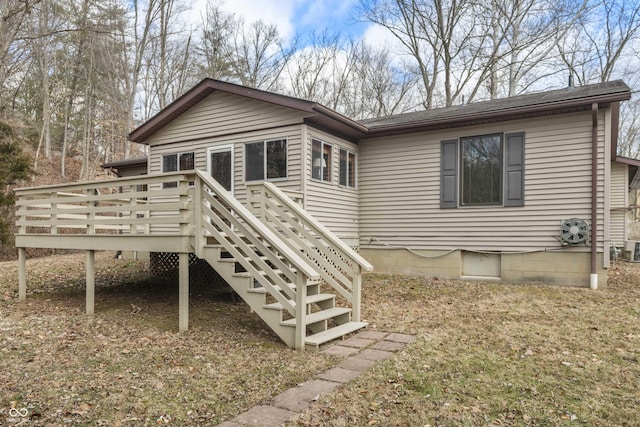 back of property with stairs and a deck