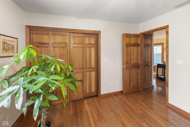 interior space with baseboards, visible vents, and light wood-style floors