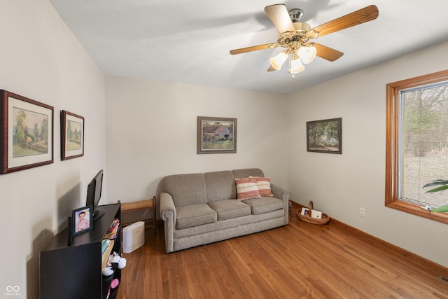 living area featuring ceiling fan and wood finished floors