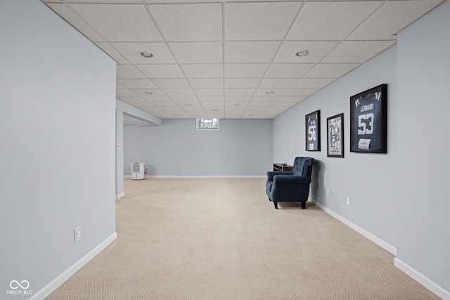 unfurnished room featuring carpet floors, a drop ceiling, and baseboards