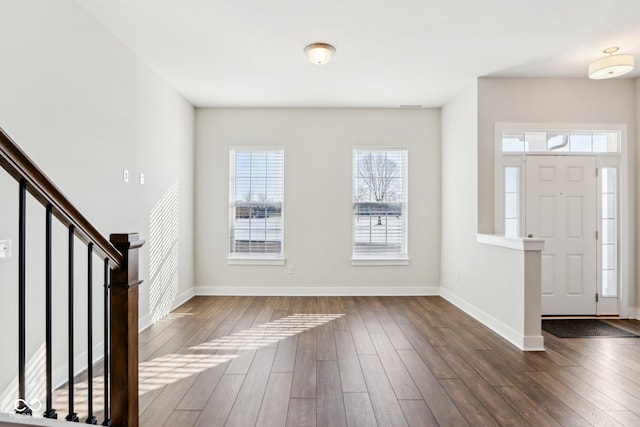 foyer featuring stairs, baseboards, and dark wood-style flooring