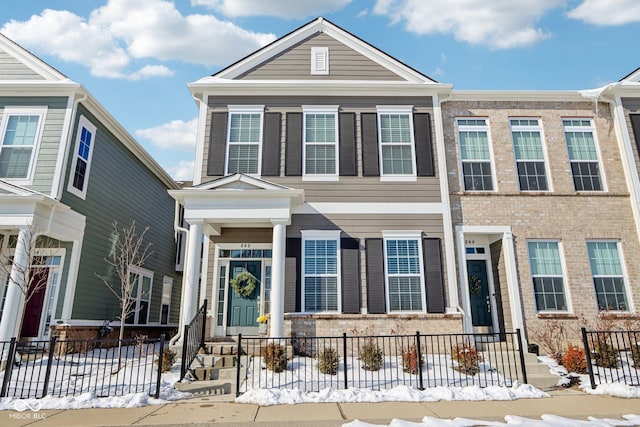 view of front of home with fence and brick siding