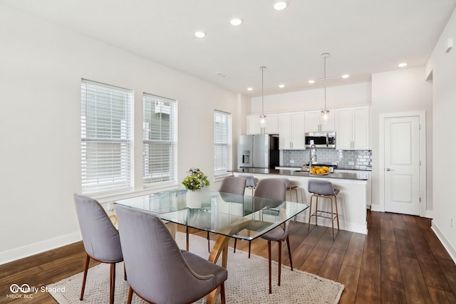 dining area with baseboards, dark wood finished floors, and recessed lighting