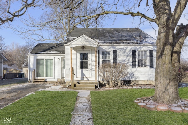 bungalow-style home featuring a front yard