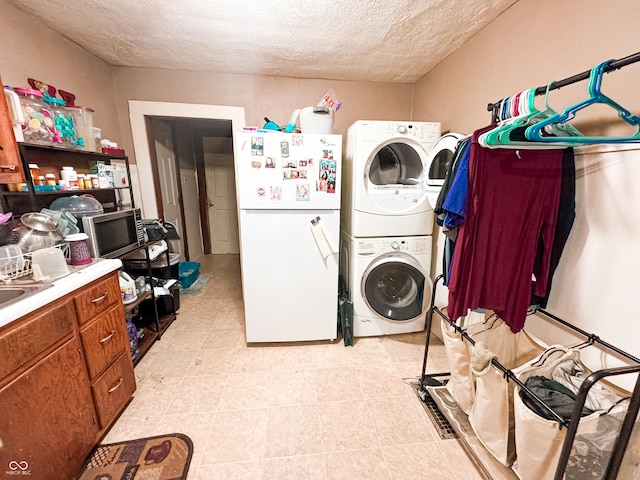 laundry area featuring stacked washer / dryer and a textured ceiling