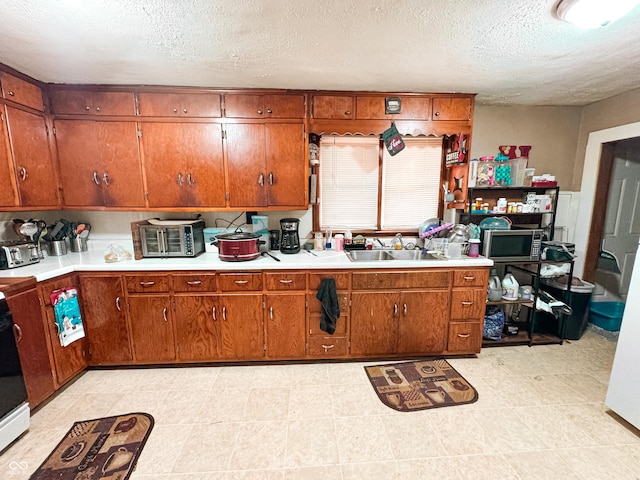 kitchen featuring sink and a textured ceiling