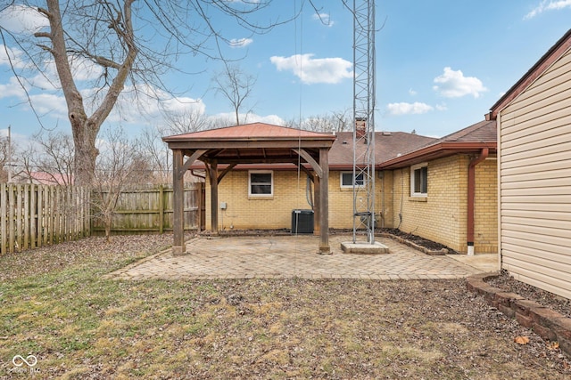 rear view of property featuring central AC unit and a patio area