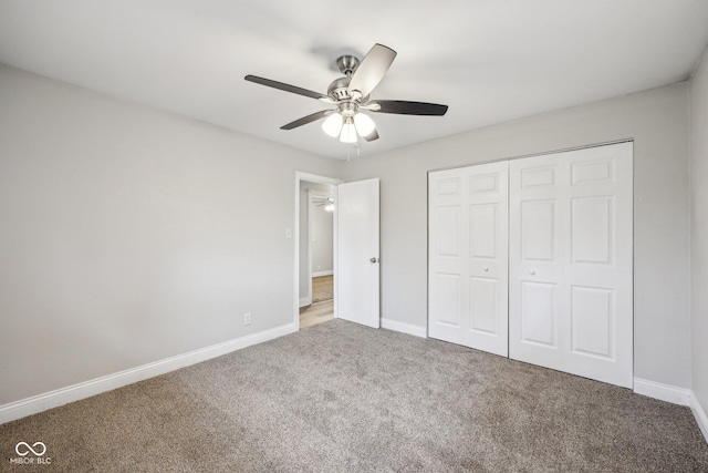 unfurnished bedroom featuring carpet flooring, ceiling fan, and a closet