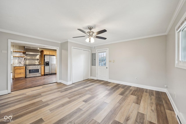 unfurnished living room with hardwood / wood-style flooring, ornamental molding, and ceiling fan