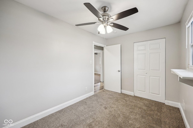 unfurnished bedroom with carpet floors, ceiling fan, and a closet