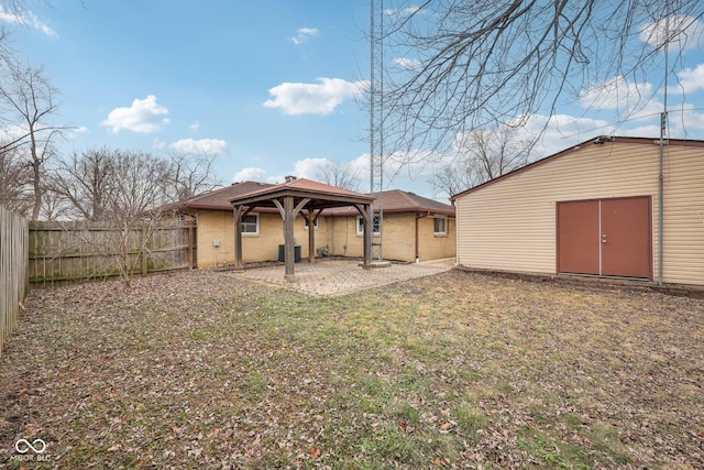 back of property with a gazebo, a yard, cooling unit, and a patio