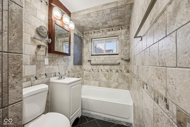 bathroom featuring vanity, tile patterned floors, toilet, and tile walls