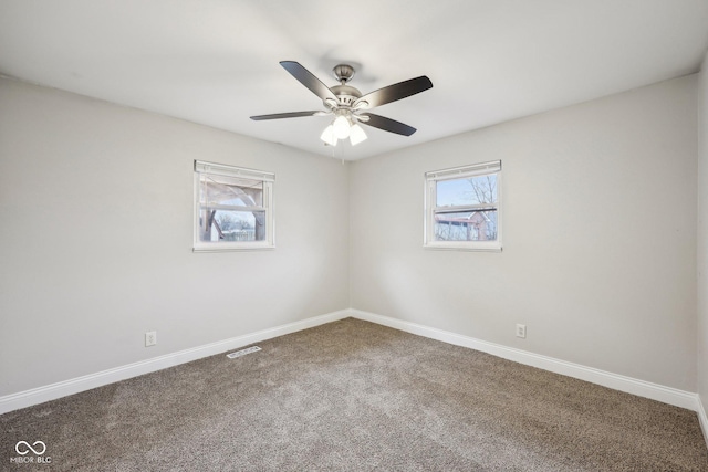 carpeted spare room featuring ceiling fan