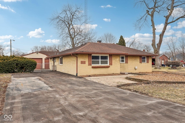 view of front of house with a garage and an outdoor structure