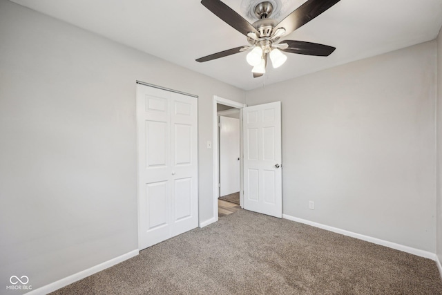 unfurnished bedroom featuring carpet flooring, ceiling fan, and a closet