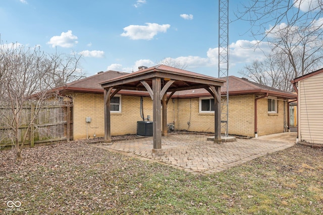 back of house with central AC and a patio