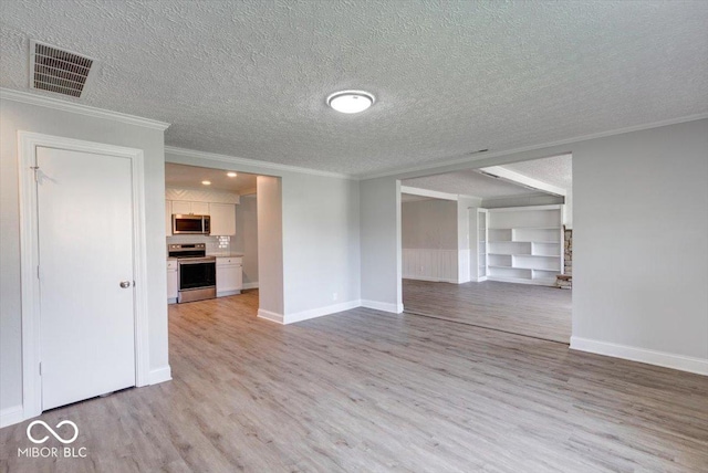 1002 Payton Ave, Indianapolis, IN 46219 - unfurnished living room with ornamental molding, light hardwood / wood-style floors, and a textured ceiling