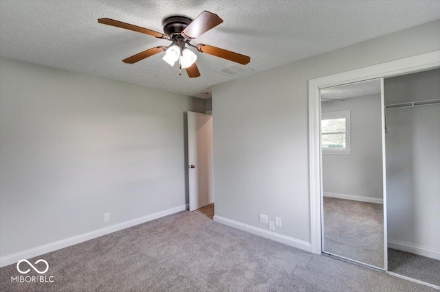 1002 Payton Ave, Indianapolis, IN 46219 - unfurnished bedroom with ceiling fan, light colored carpet, a textured ceiling, and a closet