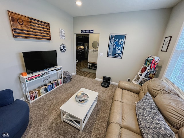 carpeted living area featuring baseboards and recessed lighting