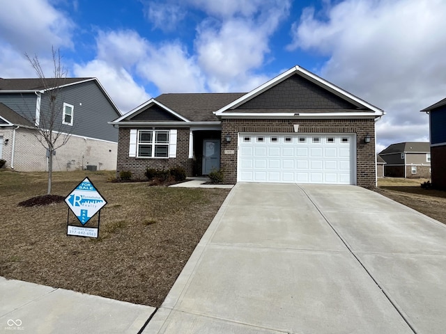 view of front facade featuring a garage, concrete driveway, and brick siding