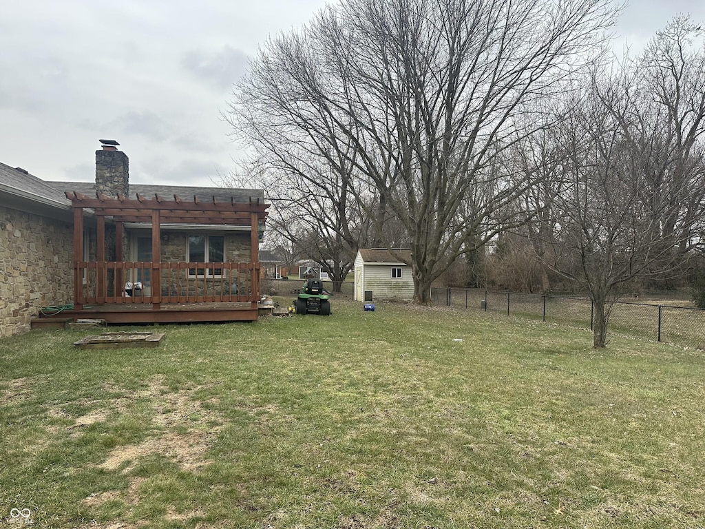 view of yard with a pergola, a deck, and a shed